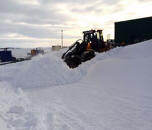 Dozer clearing snow off a road