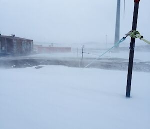 A snowy walkway with rope, strung between poles