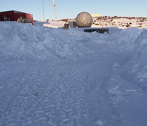 A cleared road with snow banked up on the sides