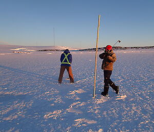 Two men practising golf