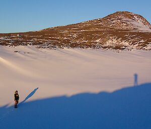 A man at the bottom of a hill