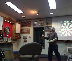 A person throwing a dart