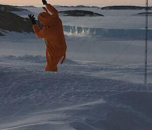 A man dressed as a pokemon against a backdrop of ice