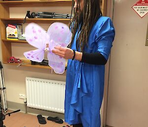 A man holding a pair of fairy wings