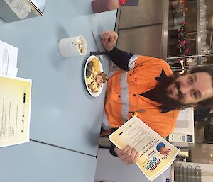 a man eating breakfast with a quiz