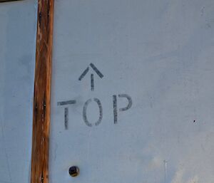 a panel with ‘top’ stamped on and arrows