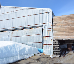 A large steel building with a roller door