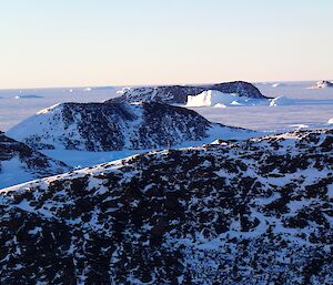 A view across several small hills and sea ice