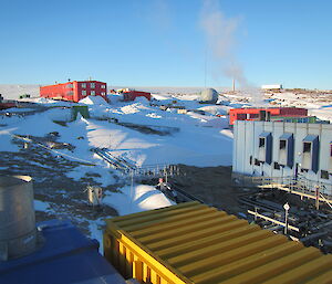 a hill with a red and blue building on the hillside