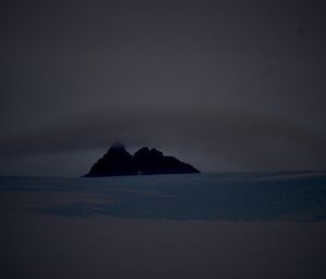 A band of cloud on top of a Mountain