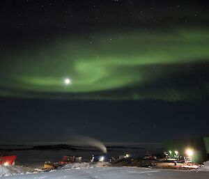 A large aurora in front of the moon
