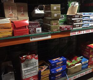 Shelves with a variety of chocolate bars on them.