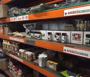A set of shelves with bags and bottles of herbs and spices