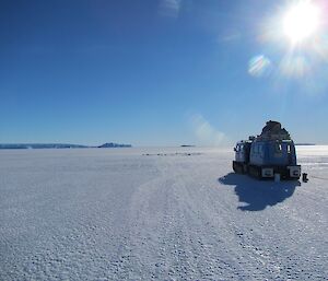 a wide expanse of sea ice with a small hole in the middle