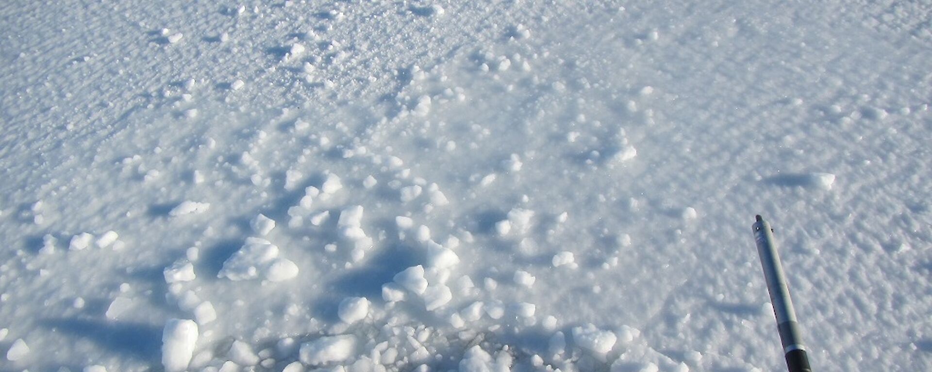 A yellow Hägglunds sinking into the sea ice