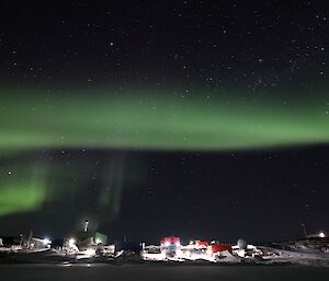 A green aurora over the station buildings