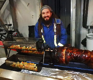 A picture of an expeditioner cooking a pig on the spit