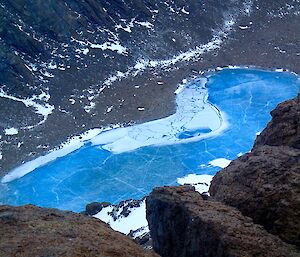 Looking down at a bright blue frozen lake