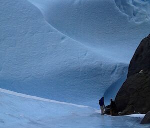 A large wall of ice with wave type formations made by the wind