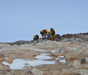 two men and a camera on the rocks