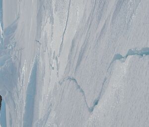 a large crack through the sea ice leading to a large mound of ice that has frozen on top of each other