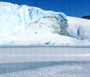 A ice cliff with a line of sediment running through it