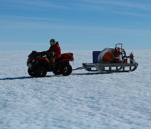 A person positioning the fire sled prior to the Basler plane arrival