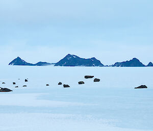 A view of the David Range from Rumdoodle hut with fallen rocks forming part of a moraine in the foreground