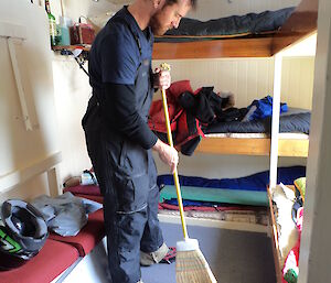 An expeditioner cleaning up the hut before departing back to station the next day