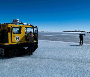 Drilling the sea ice to determine the thickness where there is a distinct change in colour