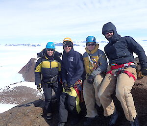 Four expeditioners on the summit of Mt Henderson in the Framnes Mts near Mawson Station