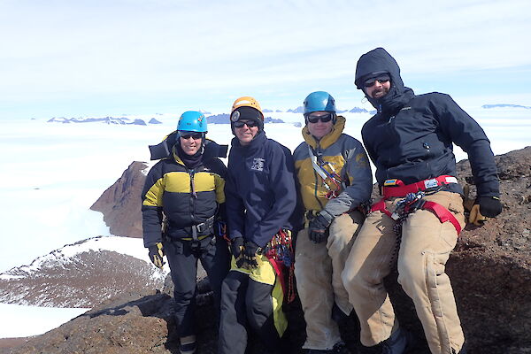Four expeditioners on the summit of Mt Henderson in the Framnes Mts near Mawson Station