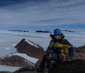 Heidi Godfrey on the magnificent crystalline rock that forms the summit of Mt Henderson — with the David and Central Masson Ranges in the background