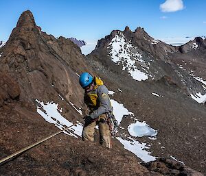 An expeditioner heading back down from Rumdoodle Peak in the Central Masson Range near Mawson Station
