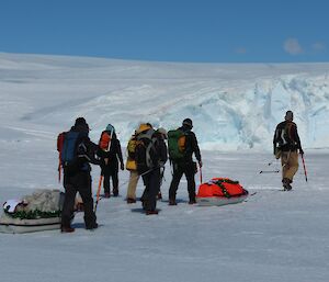 The seven heading to Bechervaise Island walk onto the sea ice near Mawson station