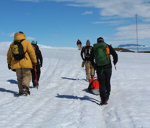 The seven member team heading to Beche Is head off Mawson station with sleds