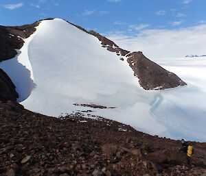 Heidi Godfrey heads down a scree slope towards a wind scoop