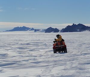 Ben Newport on a quad on the plateau navigating to Rumdoodle hut near Mawson