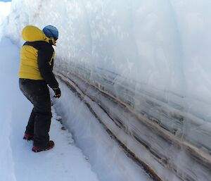 Heidi Godfrey checks out the layers of dirt in the ice in a wind scoop near Fearne Lake