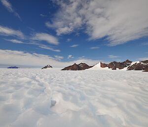 A picture of the Northern and Central Massons ranges in the background with an ice plateau in front.