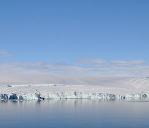 A view along West Arm with the explosives hut visible to the left and the spectacular ice cliffs along the coast to the west.