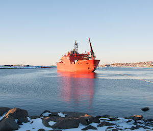 The Aurora Australis in the harbour at Mawson in calm waters.