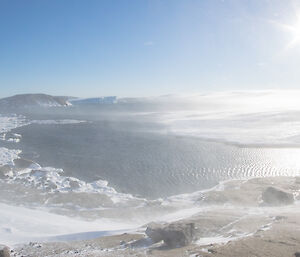 A view from Mawson looking to the east — the wind is still blowing snow but the sun is shining through and the skies have cleared