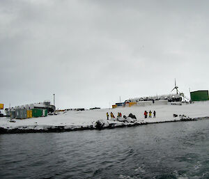 Station personnel waiting on the shore at Mawson for the IRBs to take them out to the ship for breifings before resupply starts