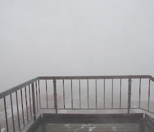 A view from the Red Shed entrance showing blowing snow during a blizzard recently at Mawson