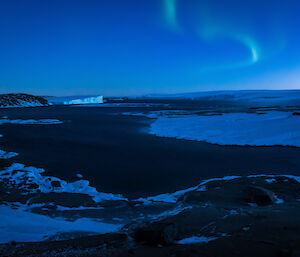 The aurora australis is clearly visible in the night sky above Mawosn as the moon moves around