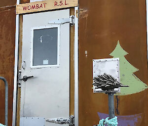 A metal Echidna is located on a pole in front of a building named the Wombat RSL