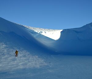 a man stands in front of a blue icy range