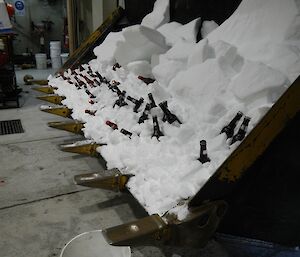 the front loader is filled with ice holding drinks