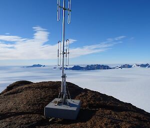A radio aerial sits on top of Mt Parsons with the North Masson Ranges and Mt Henderson in the distance